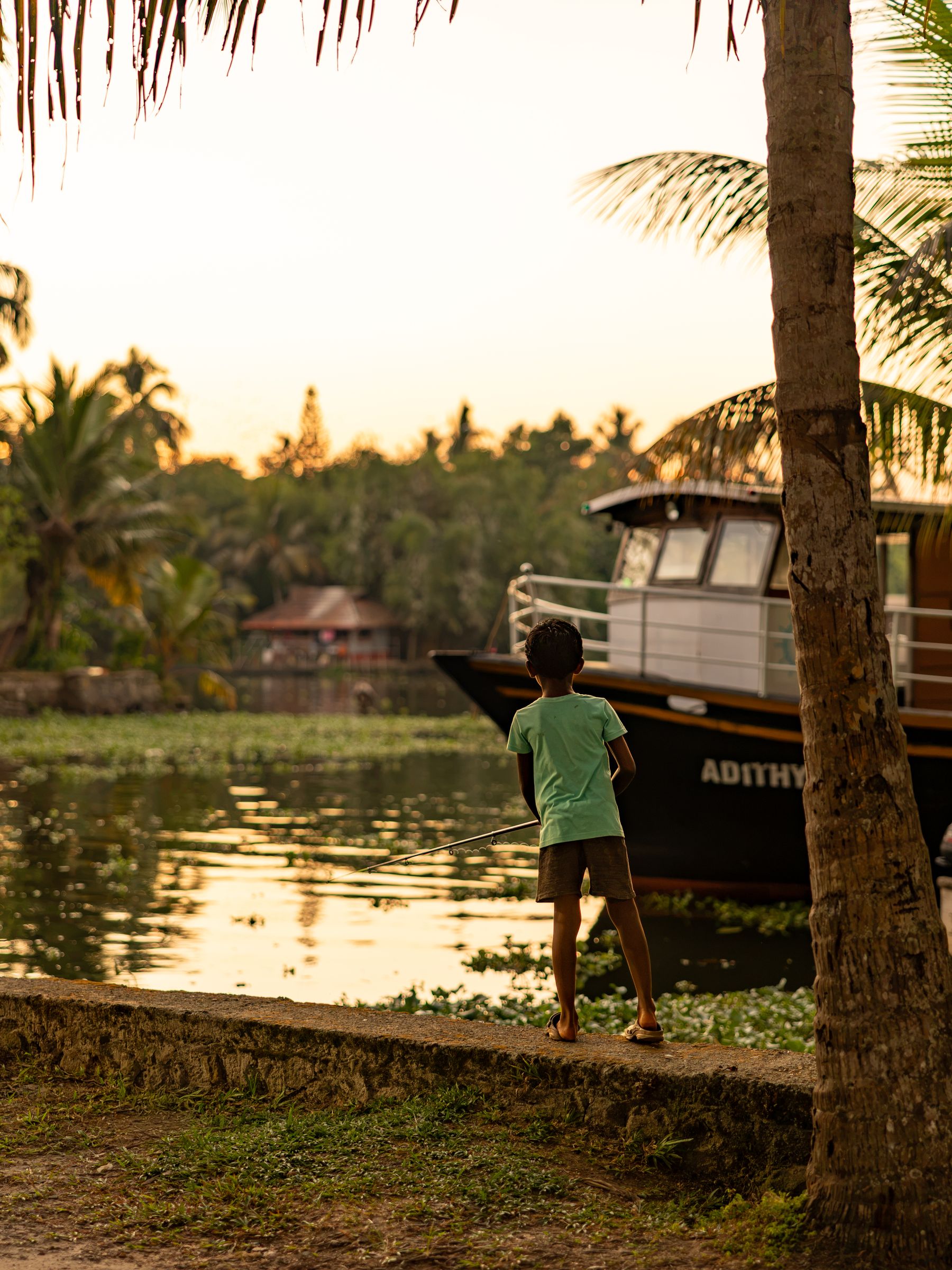 Child Fishing Beside Houseboat